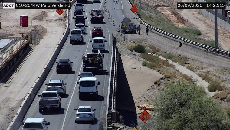Construction cones and workers in the right lane