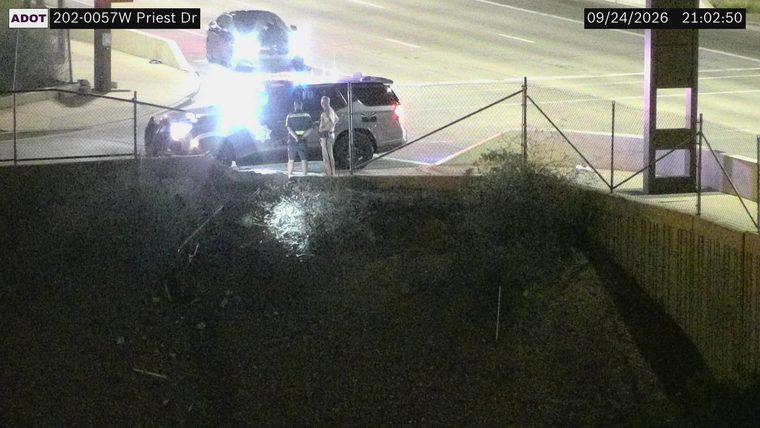Police vehicle with lights on the shoulder
