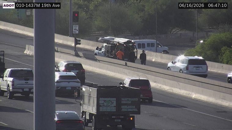 Construction vehicle with workers on the right shoulder