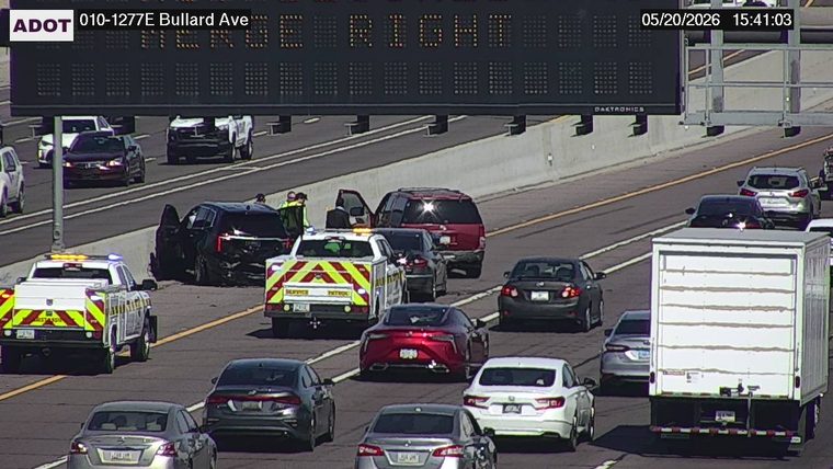 Goodyear Fire Dept truck and police vehicles with emergency lights on the left shoulder and lanes, with responders standing nearby