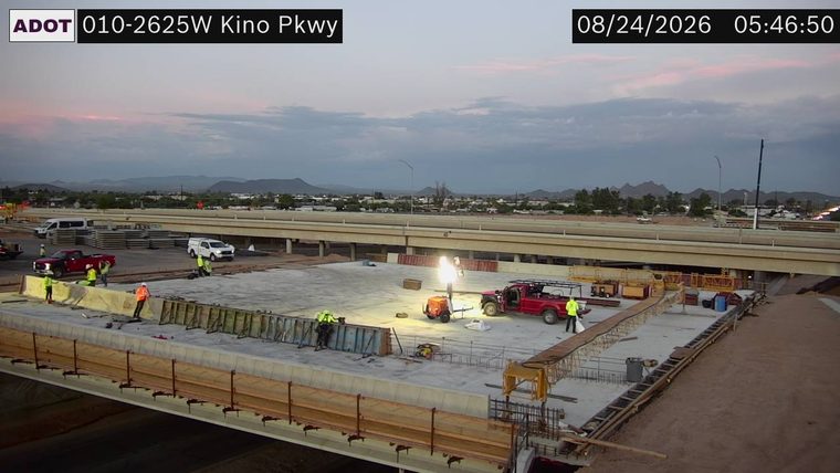 Construction workers and equipment on elevated roadway