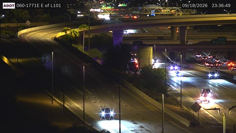 Police car with red and blue lights on the right shoulder