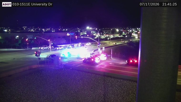 Multiple police cars with flashing lights at intersection