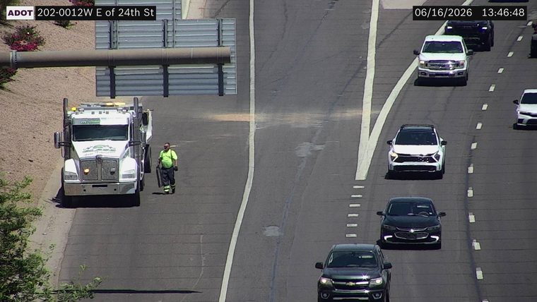 Tow truck and worker on the left shoulder
