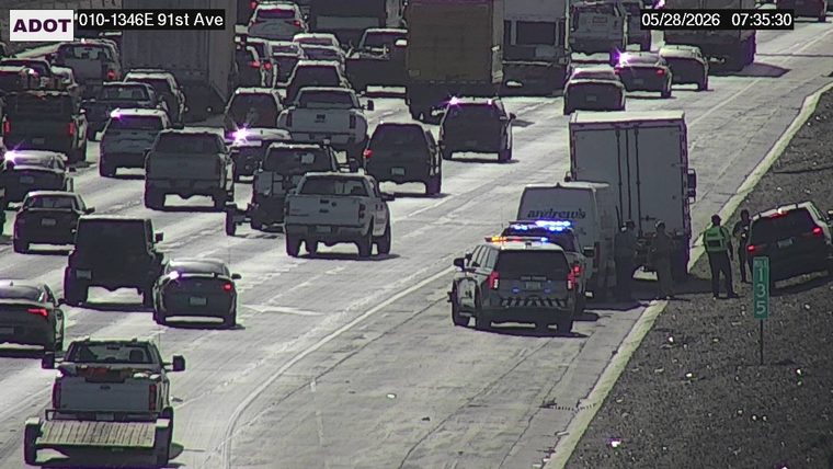 Police car with lights on the shoulder