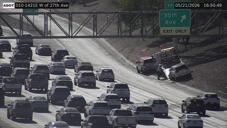 Tow truck and responder vehicle with lights on the right shoulder loading a white SUV