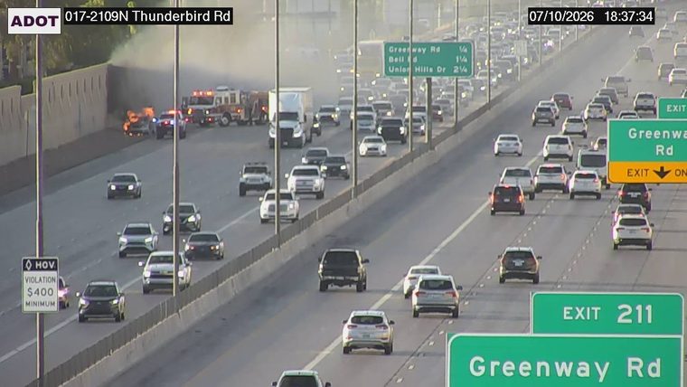 Fire and smoke in the median with fire trucks present