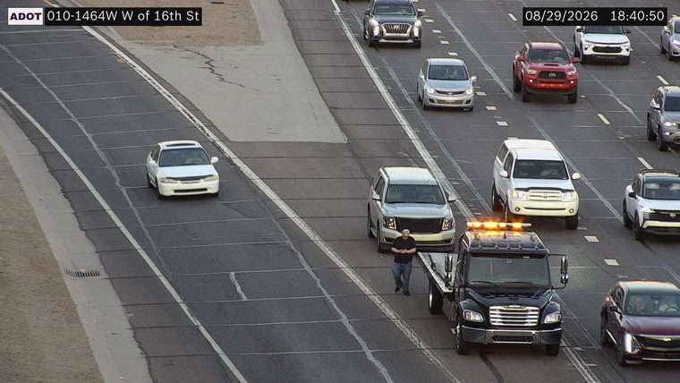 Tow truck with amber lights on in the right lane