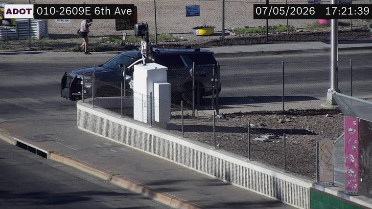 Police car with open door on the right side of the roadway
