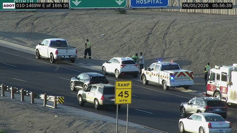 Service patrol vehicle and fire truck with emergency lights on near a white SUV in the right lane