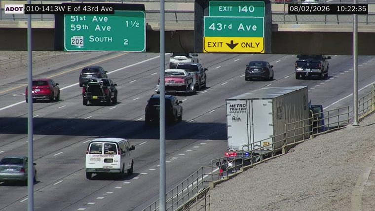 Police car with red and blue lights on the shoulder