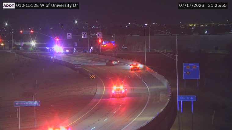 Police car with red and blue lights on the roadway
