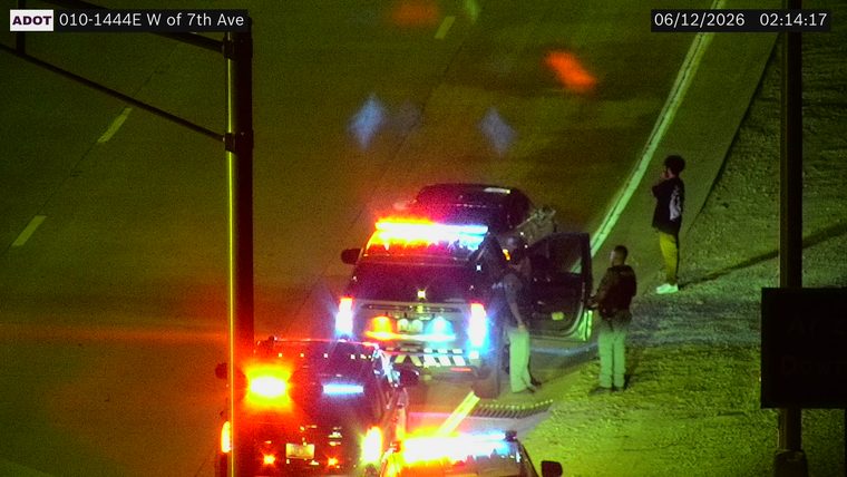 Police car with lights on the shoulder