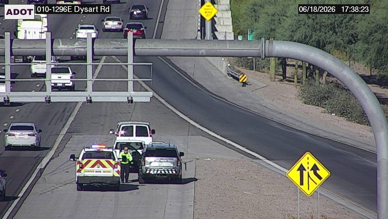 Two service patrol vehicles and a person on the right shoulder