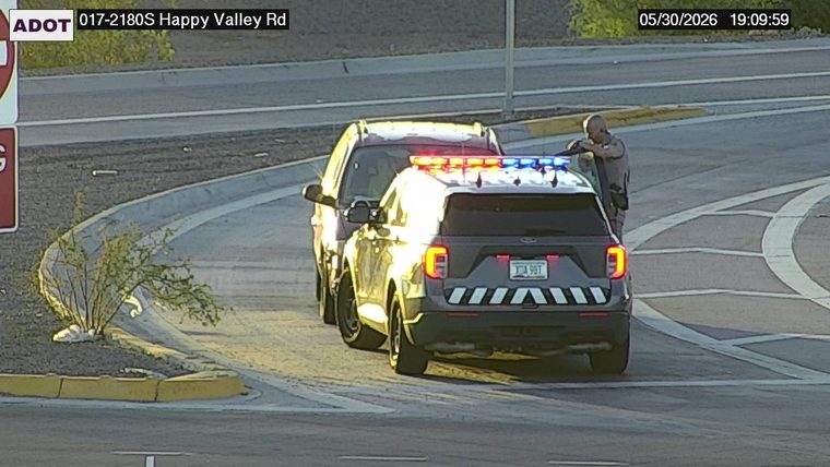 Police car with lights on the shoulder