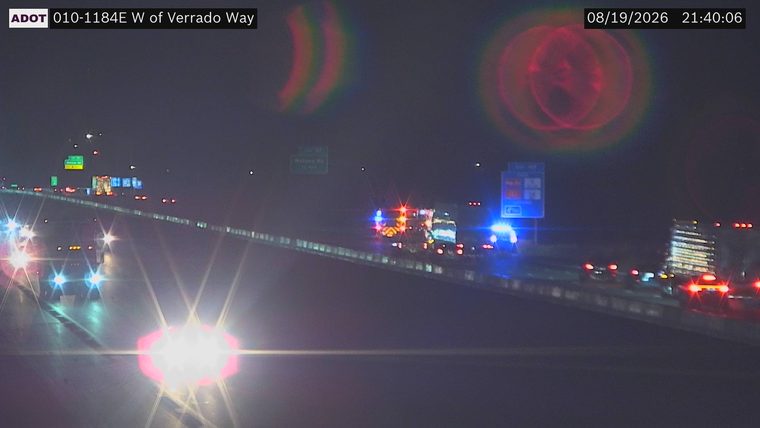 Multiple emergency vehicles with red and blue lights on the roadway