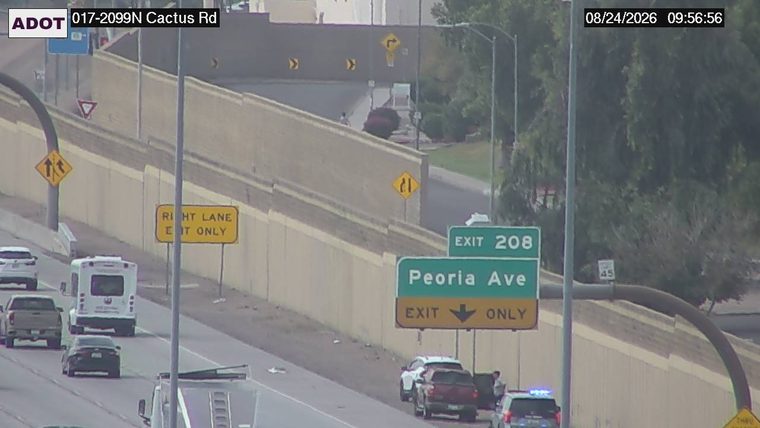 Police car with blue flashing lights on the right shoulder