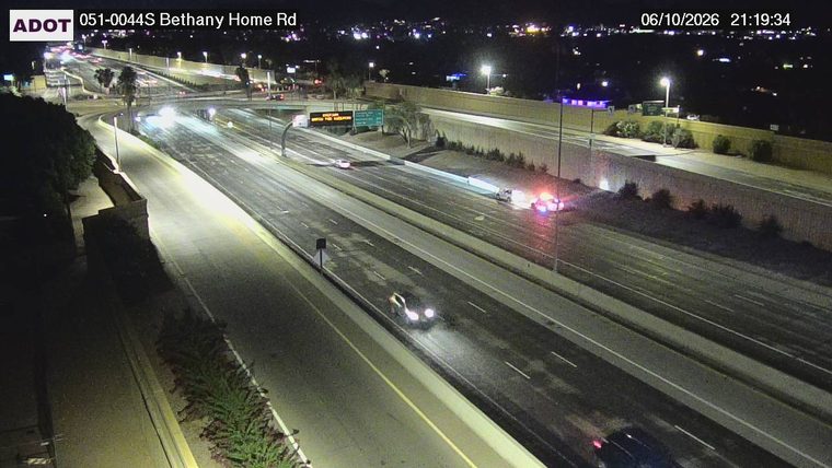 Police car with flashing lights on the right shoulder
