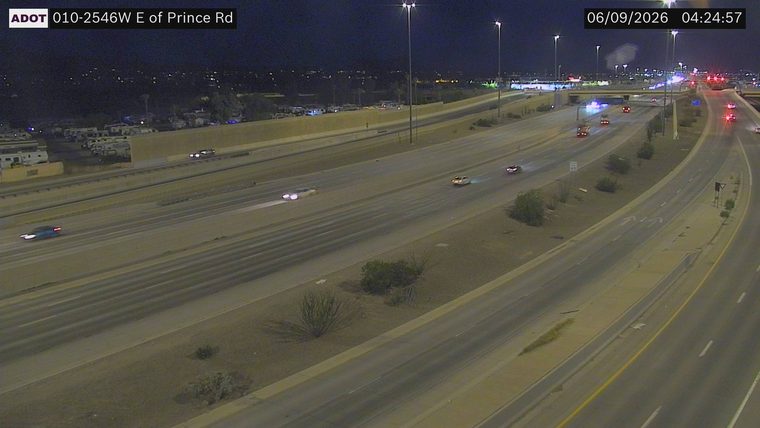 Multiple emergency vehicles with lights on in the right lanes