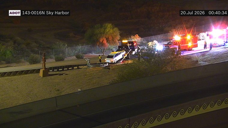 Tow truck and two emergency vehicles with lights on near a white car on the shoulder