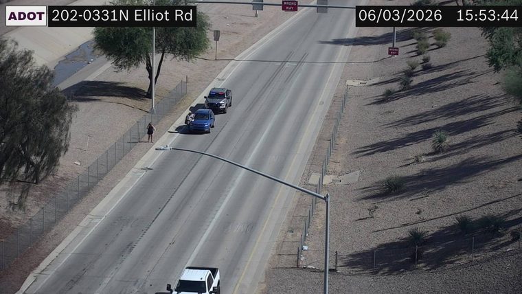 Police car and a blue sedan on the right shoulder