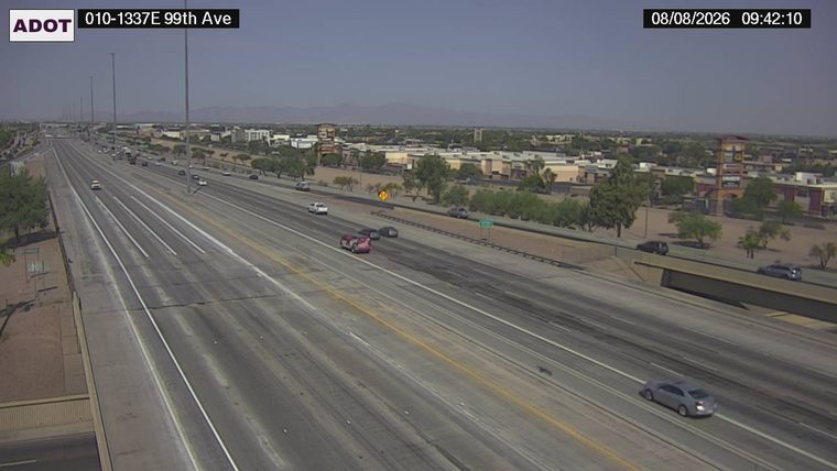 Red sedan on its side in the left lanes