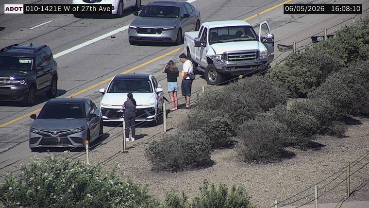 White pickup truck with visible front-end damage on the right shoulder
