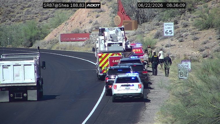 Fire truck and police cars with lights on the shoulder