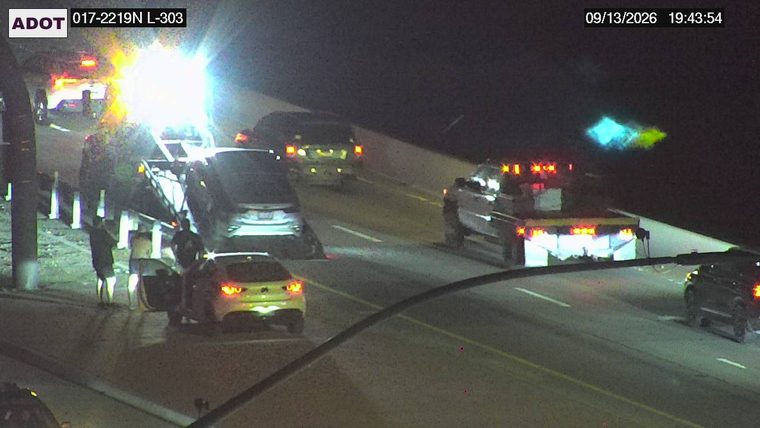 Tow truck assisting a car on the right shoulder
