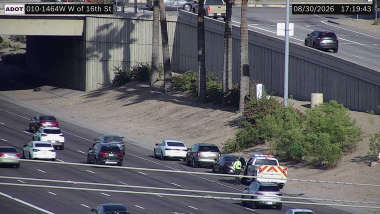 Police car with lights on the right shoulder