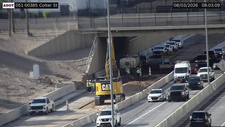 Construction workers and equipment in the roadway