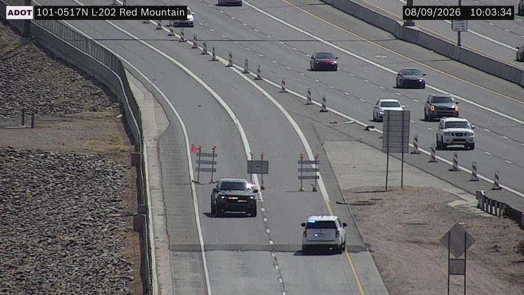 Police SUV with blue lights on in the right lane