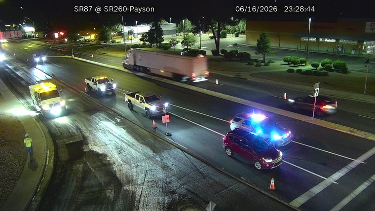 Police car with blue and red lights on the right lane