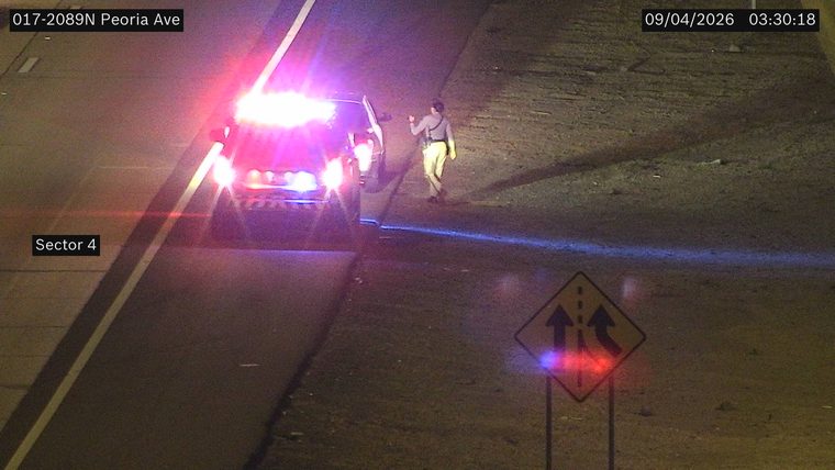 Police car with red and blue lights on the shoulder