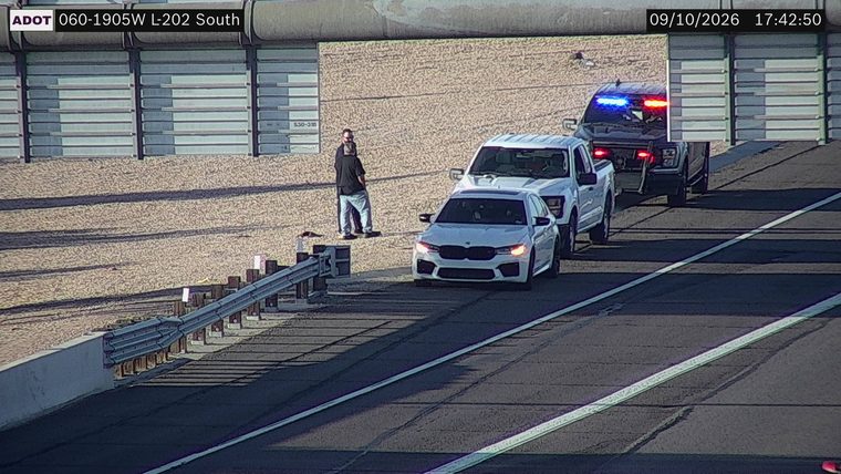 Police car with red and blue lights on the shoulder