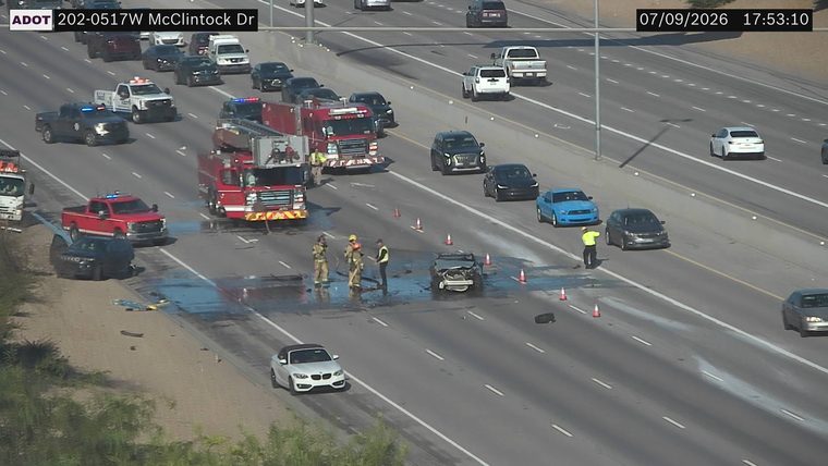 Overturned vehicle with responders and fire truck in the left lanes