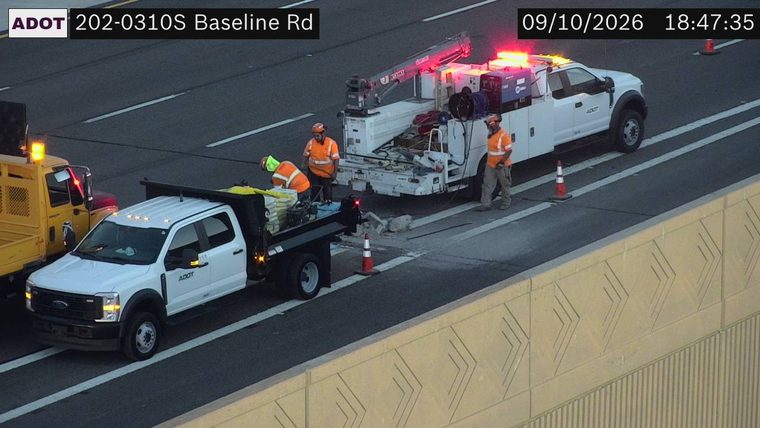 Construction workers and equipment in the right lane