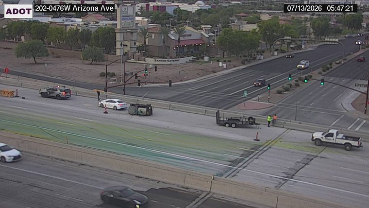 Overturned vehicle and debris in the left lanes