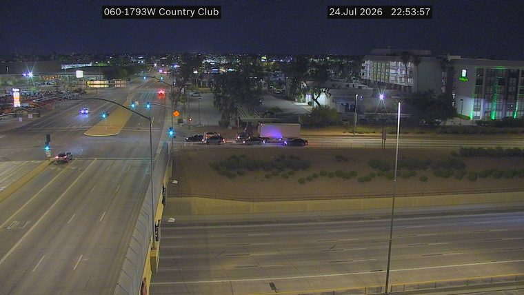 Multiple police cars and a semi-truck stopped in the right lane