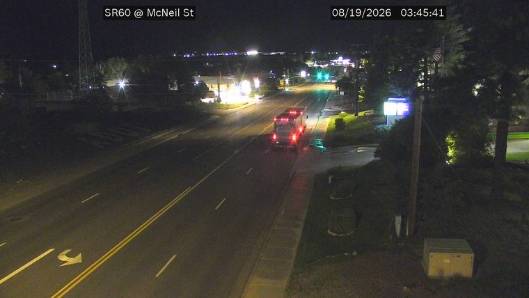 Fire truck with red flashing lights in the right lane