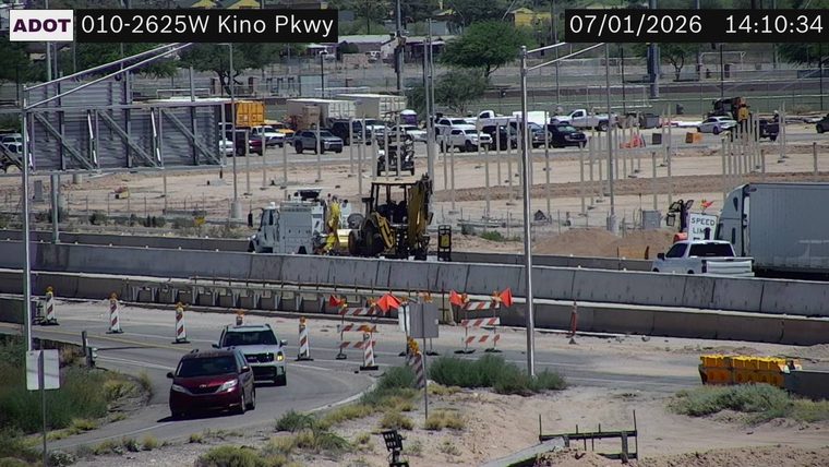 Construction equipment and workers in the roadway