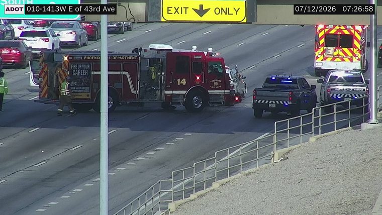 Fire truck, ambulance, and two police vehicles with lights on in the roadway