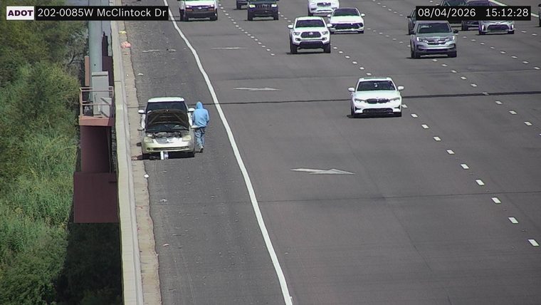 Car with hood open on the right shoulder