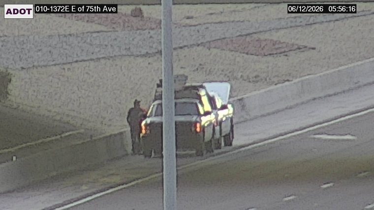 Two vehicles on the right shoulder with hazard lights on