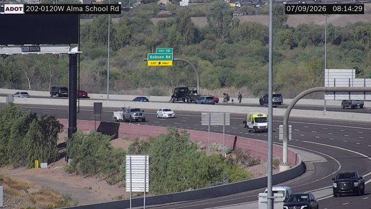 Tow truck assisting a car on the right shoulder