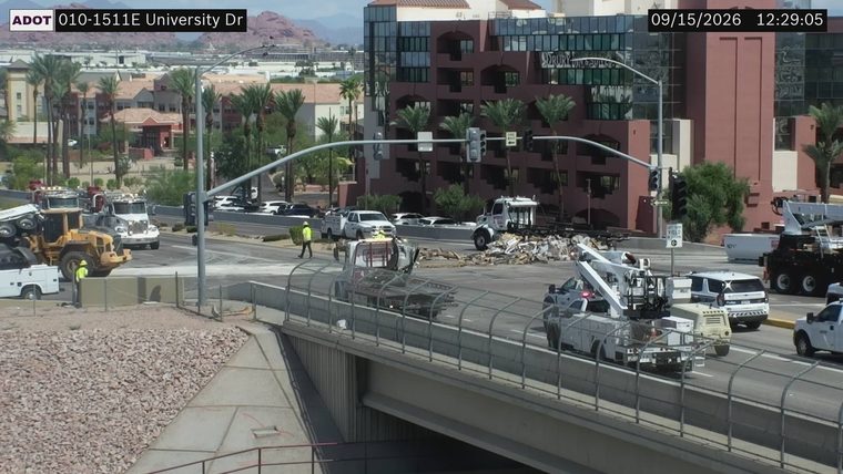 Tractor-trailer overturned and blocking lanes, with debris scattered