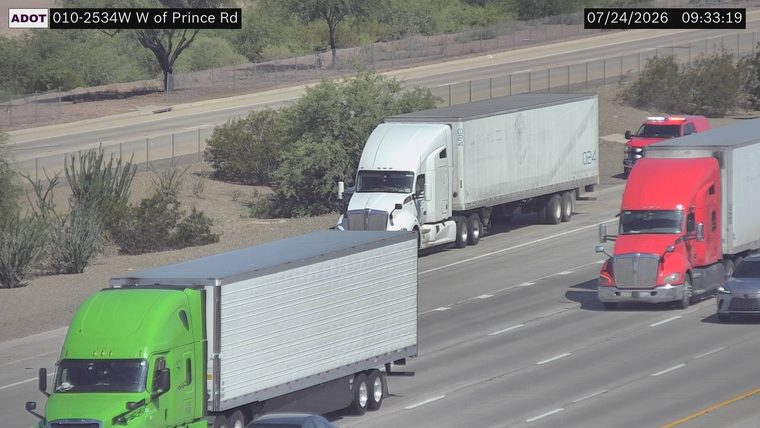 Red truck with red and white lights on the shoulder