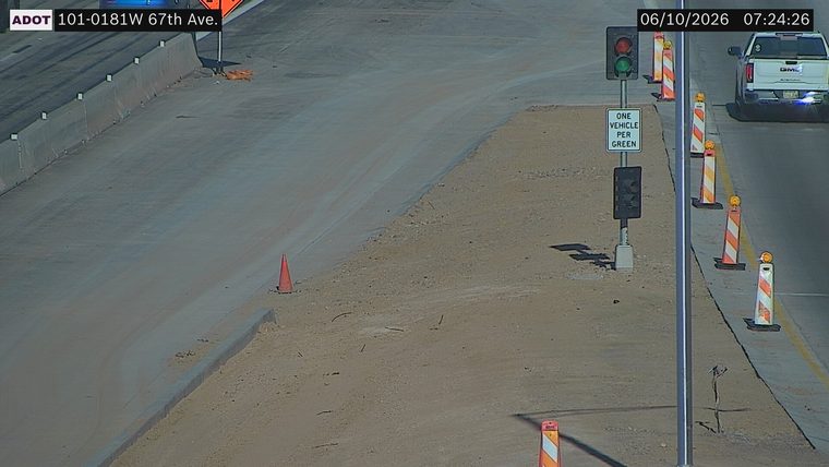 Construction cones and a traffic signal in the right lane