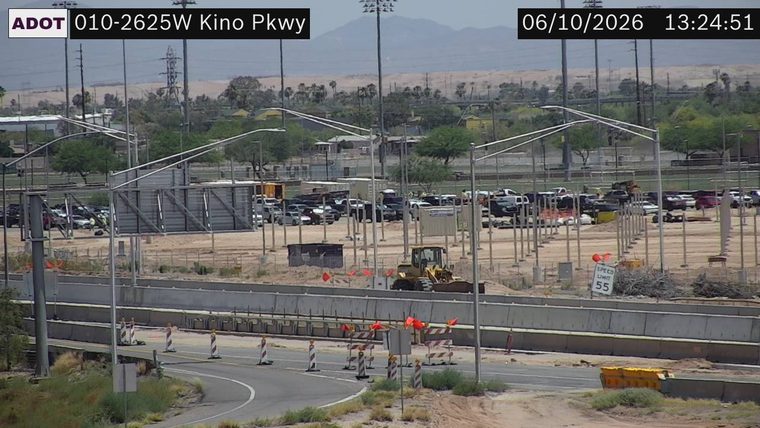 Construction equipment and orange cones on the roadway