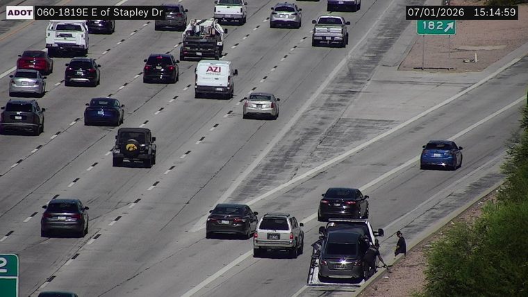 Tow truck assisting a vehicle on the right shoulder